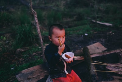 男孩耳环粮食而进行一轮白色碗和一双筷子
